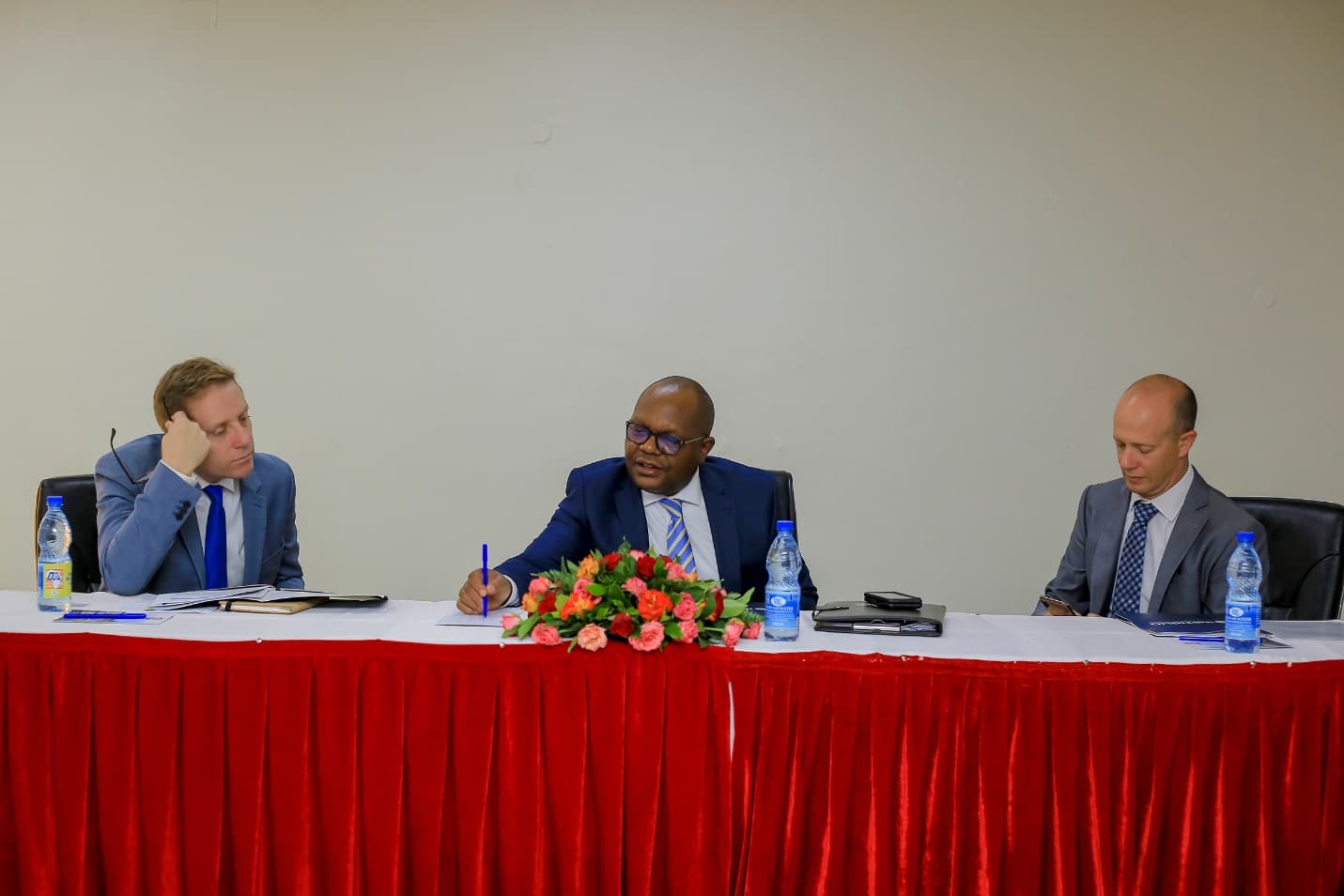 Assistant Commissioner Refugees (Centre), Mr. Douglas Asiimwe together with the head of Instinglio and the Deputy Representative UNHCR, Jason Hepps at Hotel Africana consulting on the development of the theory of change framework to support the Department of Refugees in April 2024